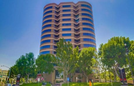 Modern office building with green trees.