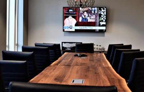 Conference room with wooden table and chairs.